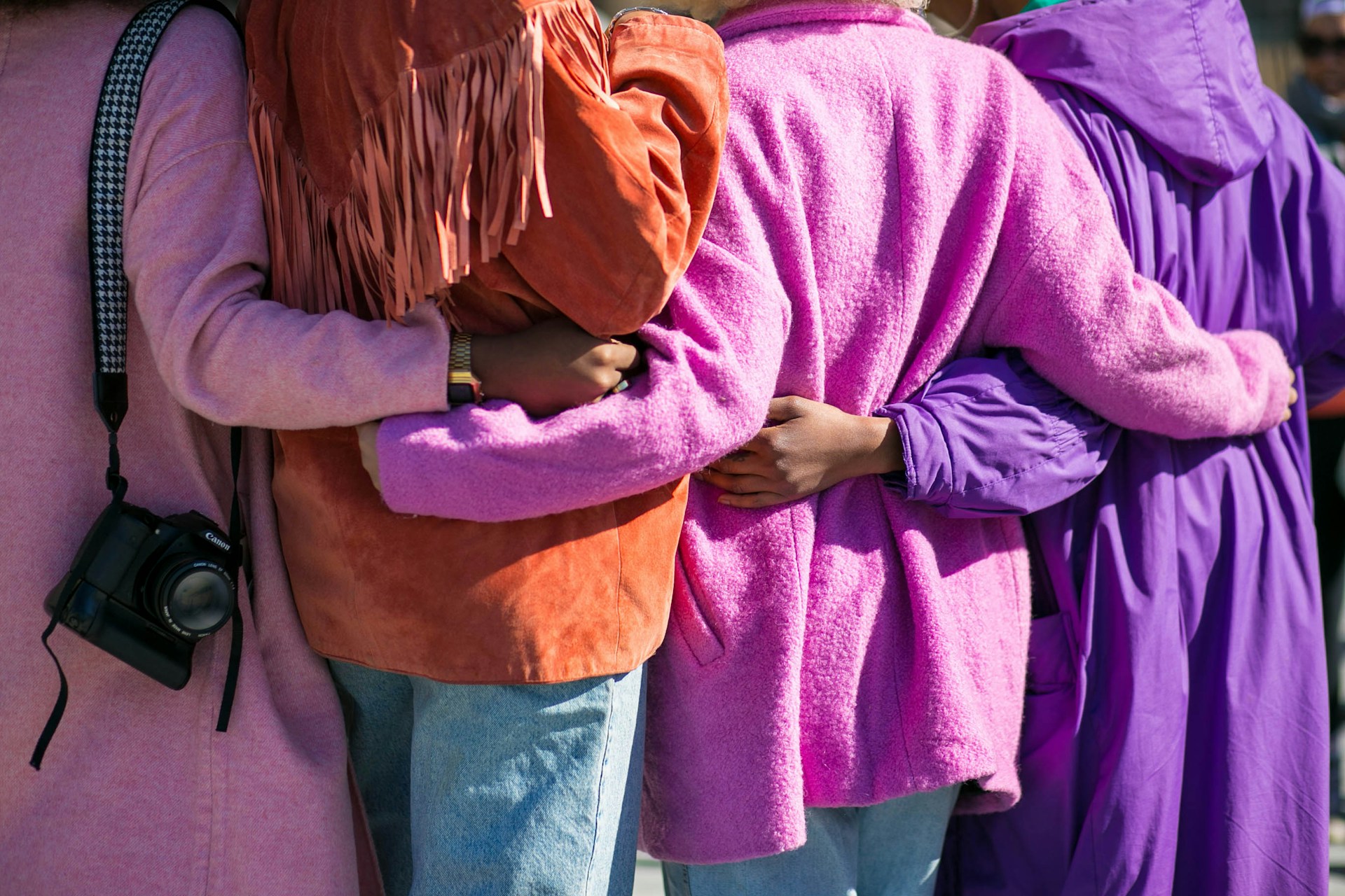 Three people with side hugs
